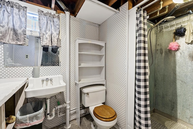 bathroom featuring a sink, wallpapered walls, toilet, and a shower with shower curtain