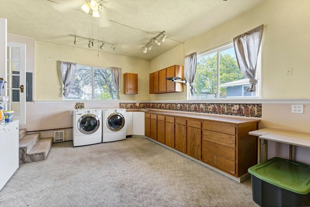 clothes washing area with cabinet space, light carpet, a ceiling fan, visible vents, and washer and clothes dryer