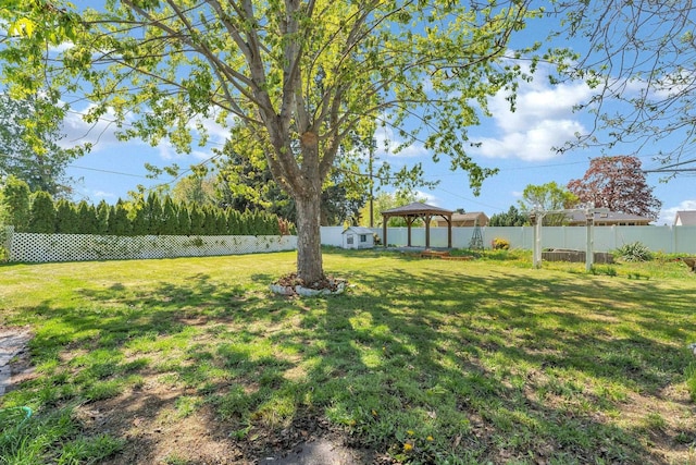 view of yard with a fenced backyard and a gazebo