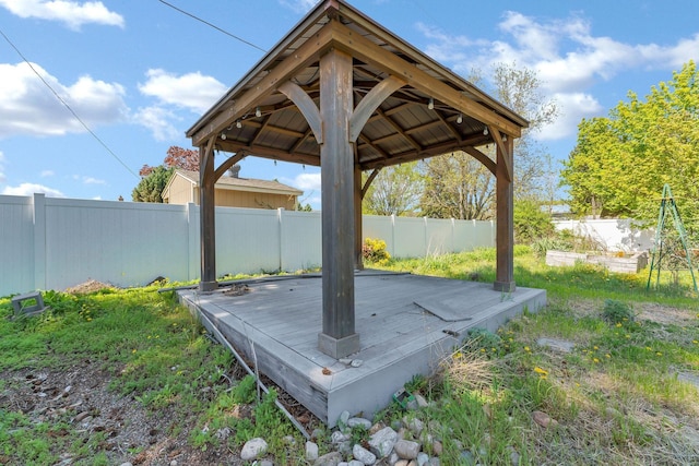 view of yard with a gazebo, a fenced backyard, and a deck