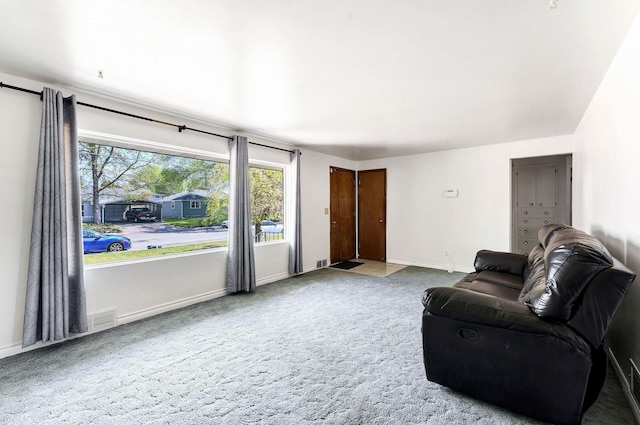 carpeted living room featuring baseboards and visible vents