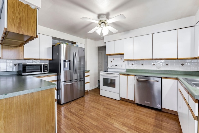 kitchen featuring ceiling fan, backsplash, stainless steel appliances, and white cabinets