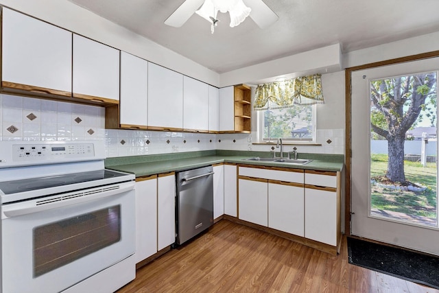 kitchen featuring wood finished floors, dishwasher, a sink, and white electric range
