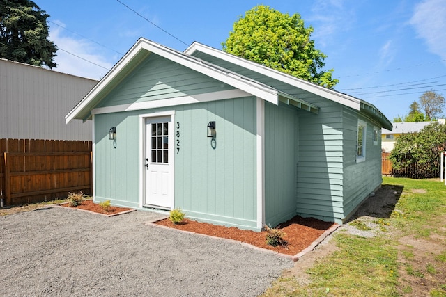 view of outbuilding with fence