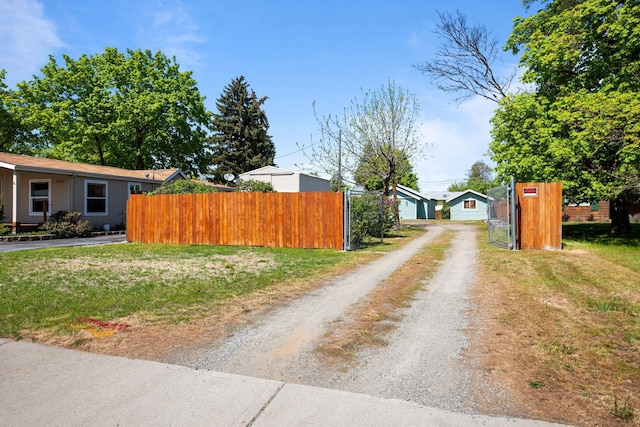 view of road featuring a gated entry and driveway