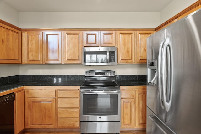 kitchen featuring tile counters and appliances with stainless steel finishes