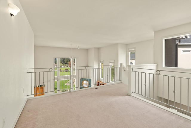 corridor featuring carpet flooring and an upstairs landing