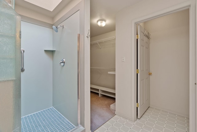 full bath with a spacious closet and a shower stall