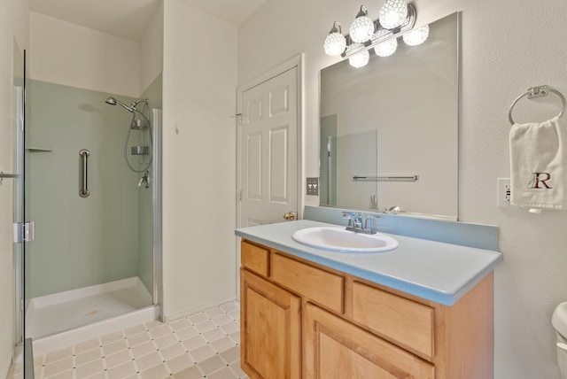 full bathroom featuring toilet, a shower stall, tile patterned flooring, and vanity