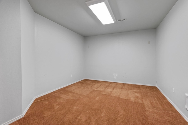spare room featuring visible vents, carpet, and baseboards