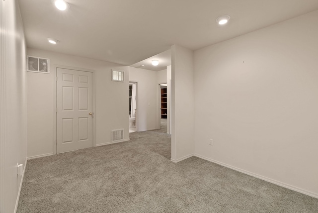 unfurnished room with baseboards, carpet, recessed lighting, and visible vents