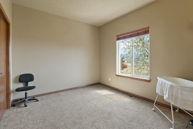 unfurnished bedroom featuring carpet floors, baseboards, and visible vents