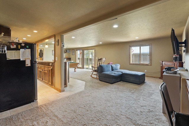 living area featuring light tile patterned floors, light carpet, recessed lighting, and a wealth of natural light