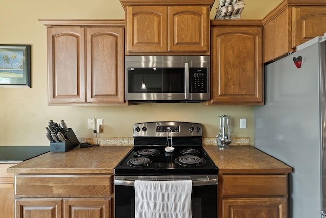 kitchen with stainless steel appliances and dark countertops