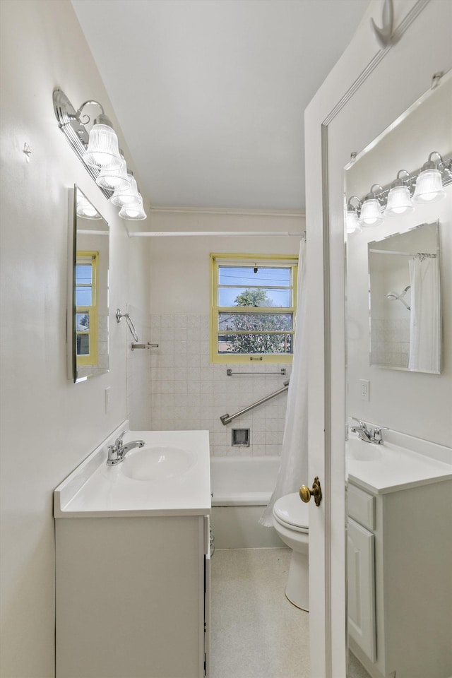 bathroom with vanity, toilet, and shower / bath combo with shower curtain