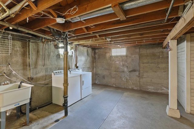 basement featuring a sink and washer and dryer