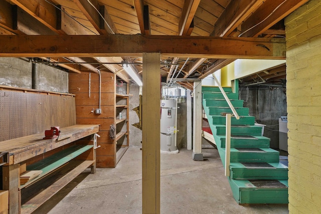 unfinished basement with strapped water heater and stairs