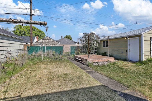 view of yard with fence and a deck