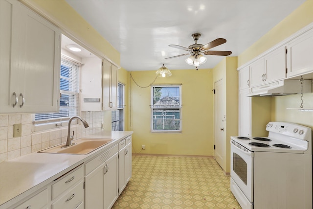kitchen with a sink, light countertops, tasteful backsplash, under cabinet range hood, and white electric stove