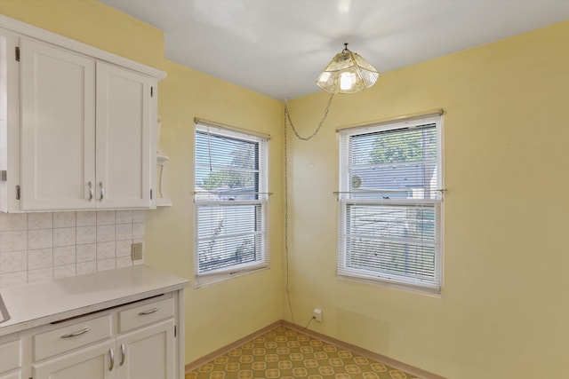 unfurnished dining area featuring baseboards and a healthy amount of sunlight