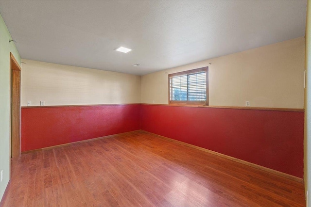 empty room with wood finished floors