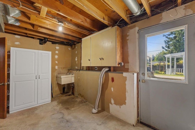 basement with a healthy amount of sunlight and a sink