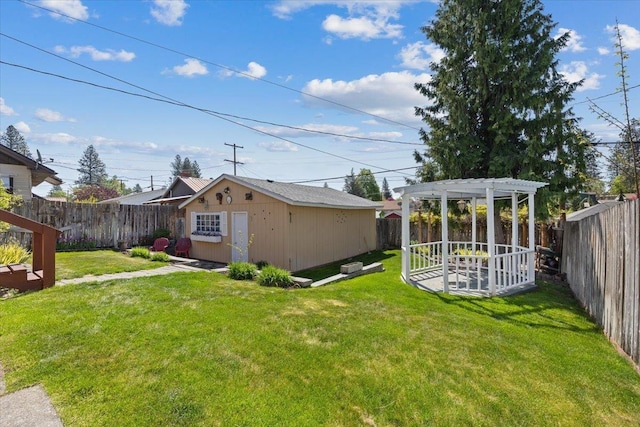 view of yard featuring a fenced backyard, a pergola, and an outbuilding