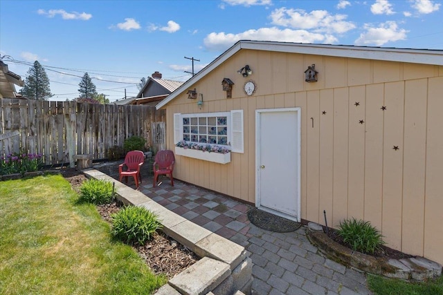 view of outbuilding featuring fence