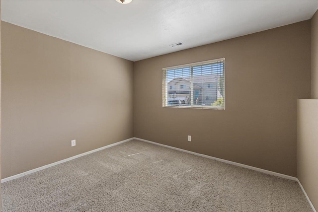 carpeted empty room with baseboards and visible vents