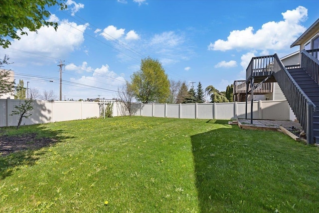 view of yard with a fenced backyard, stairs, and a wooden deck