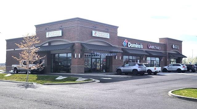 view of building exterior with uncovered parking