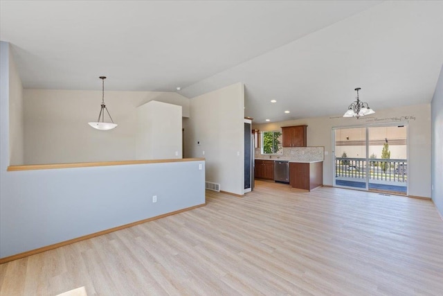 unfurnished living room featuring baseboards, a notable chandelier, and light wood finished floors
