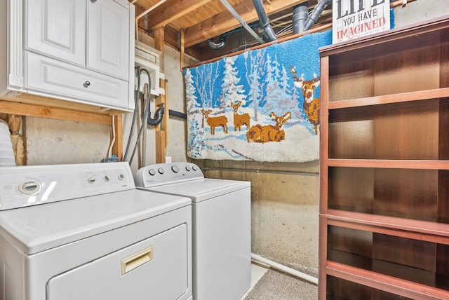clothes washing area featuring cabinet space and washer and dryer