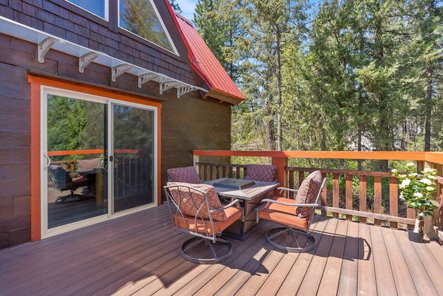 wooden terrace with outdoor dining space