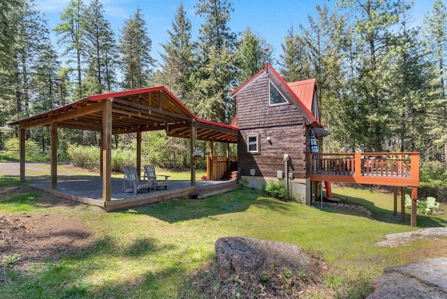view of community featuring a lawn and a wooden deck