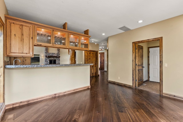 8605 E S Riverway Ave, Spokane, WA 99212 - kitchen featuring dark wood-style flooring, visible vents, a sink, glass insert cabinets, and recessed lighting