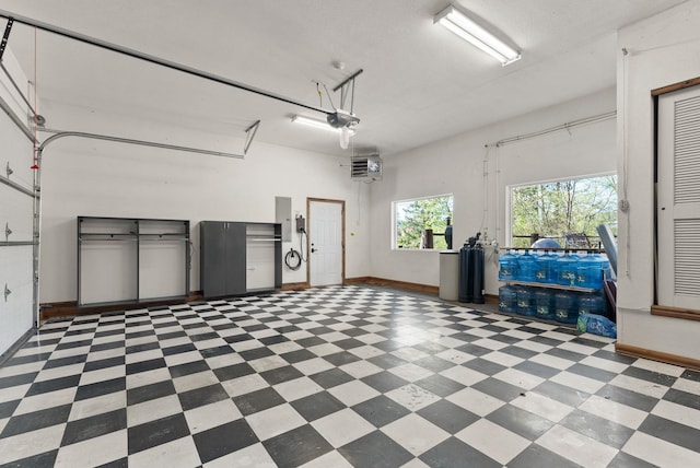 8605 E S Riverway Ave, Spokane, WA 99212 - garage featuring baseboards, a garage door opener, and electric panel