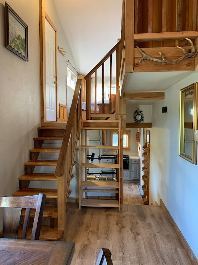 stairway featuring wood finished floors