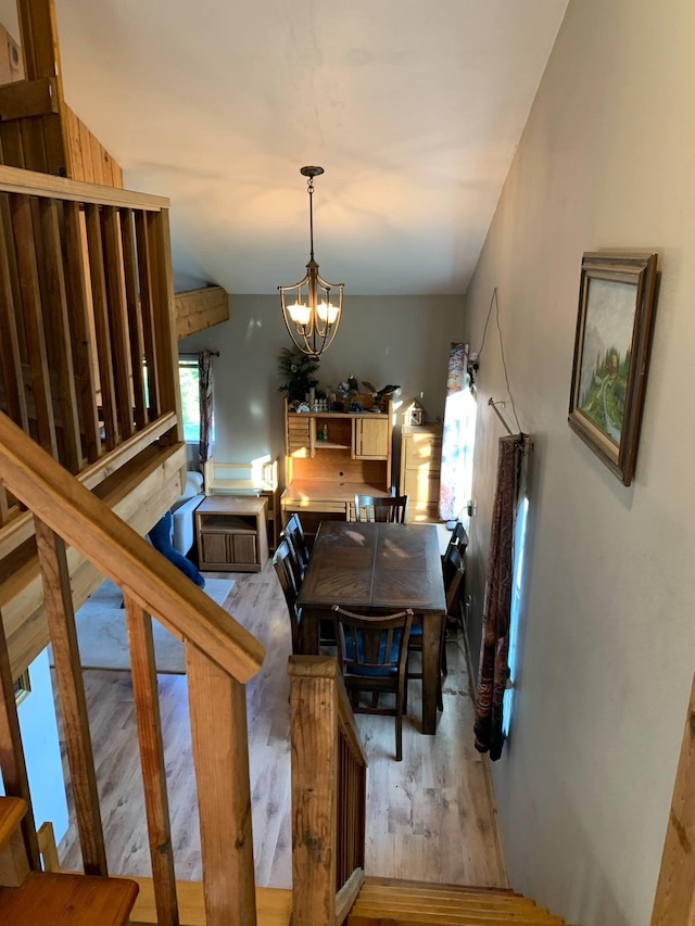 dining room featuring wood finished floors and a chandelier