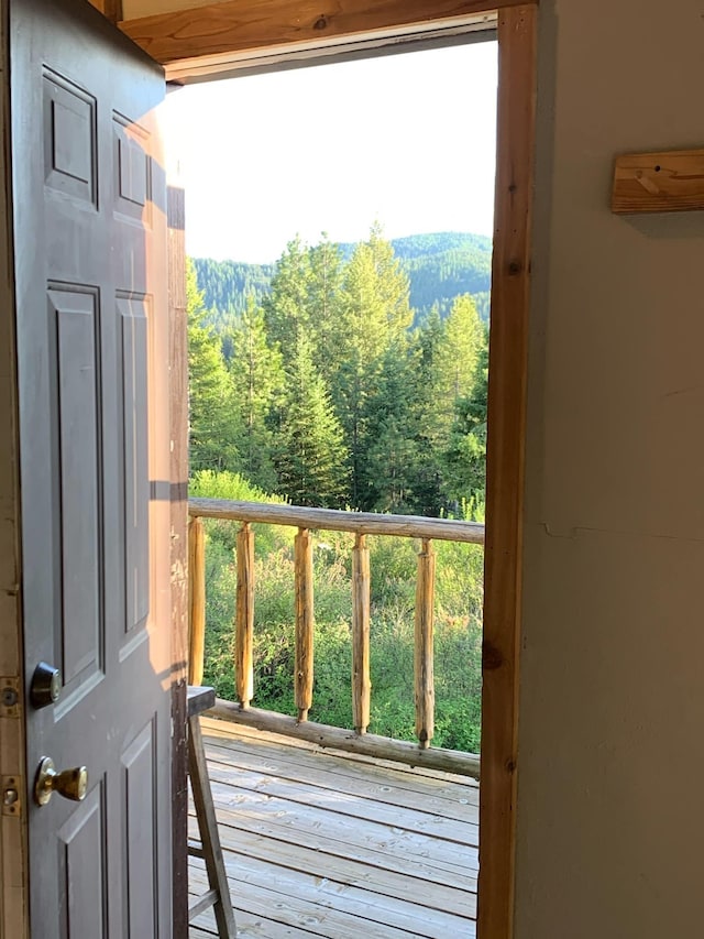 doorway to outside with a wooded view
