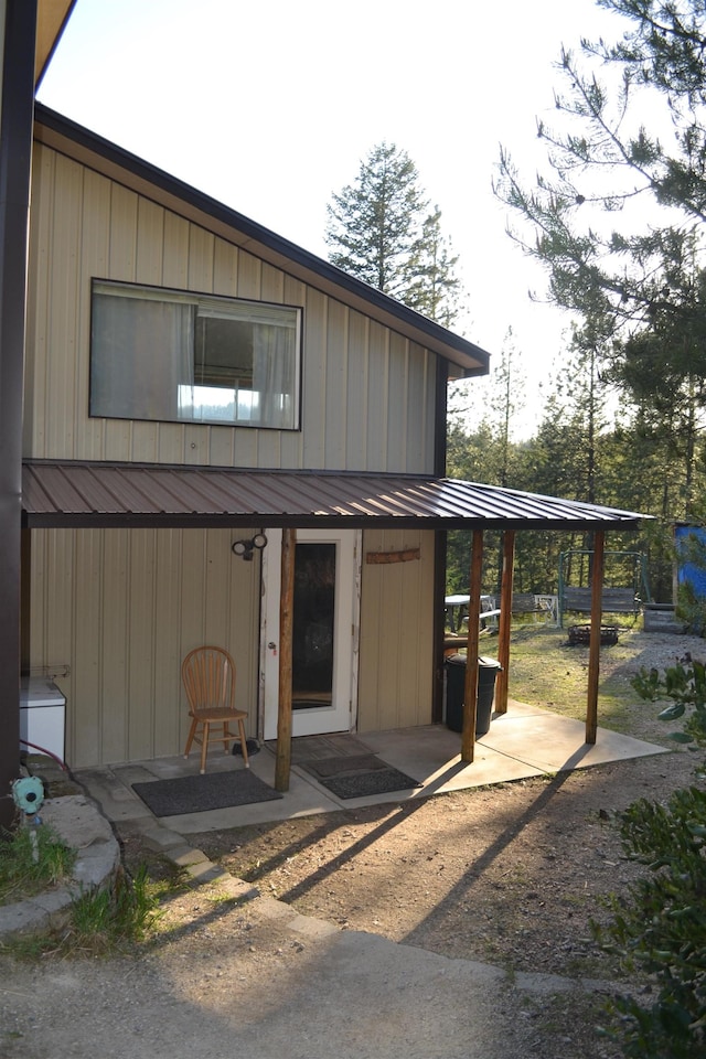 exterior space featuring a standing seam roof, a patio, and metal roof