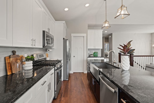 kitchen featuring recessed lighting, white cabinets, tasteful backsplash, a sink, and appliances with stainless steel finishes
