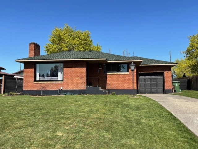 single story home with a chimney, a garage, brick siding, a front lawn, and concrete driveway