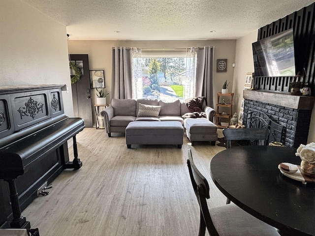 3204 W Queen Pl, Spokane, WA 99205 - living room featuring a textured ceiling, wood finished floors, and a fireplace