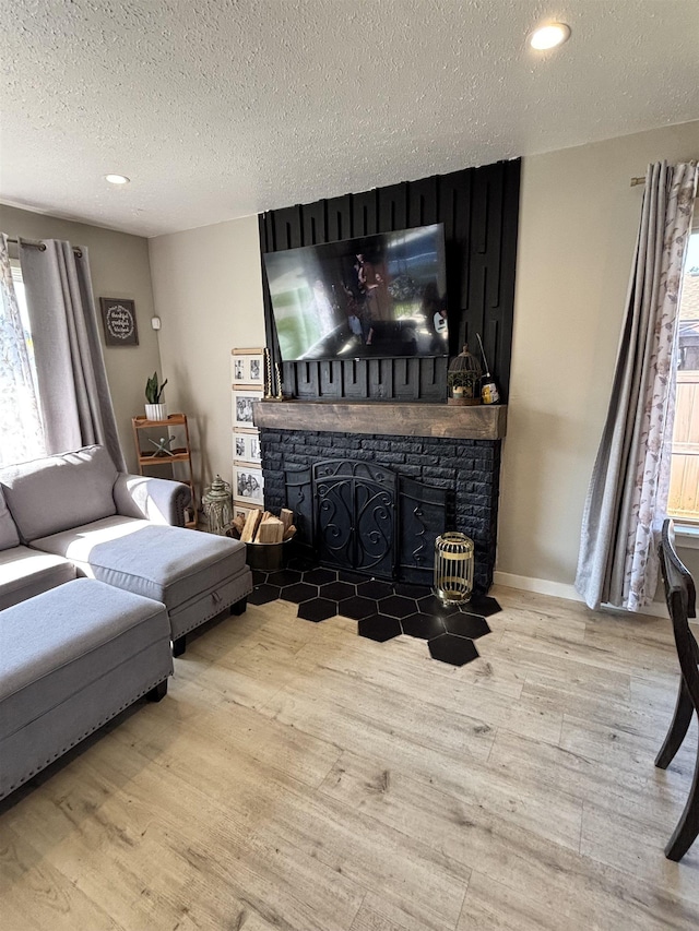 3204 W Queen Pl, Spokane, WA 99205 - living room with a fireplace, a textured ceiling, recessed lighting, and wood finished floors