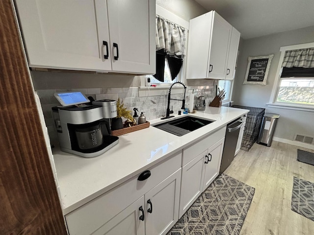 3204 W Queen Pl, Spokane, WA 99205 - kitchen featuring dishwasher, visible vents, a sink, light countertops, and light wood-type flooring