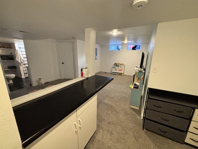 3204 W Queen Pl, Spokane, WA 99205 - kitchen featuring carpet flooring, white cabinetry, and open floor plan