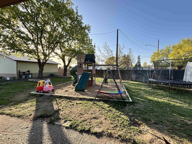 3204 W Queen Pl, Spokane, WA 99205 - view of play area featuring a trampoline, a lawn, and a fenced backyard