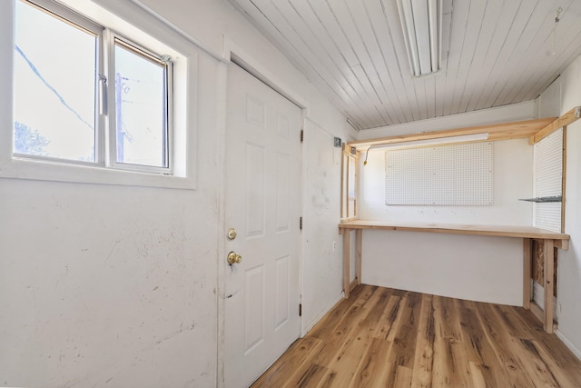 doorway featuring light wood-style floors and baseboards