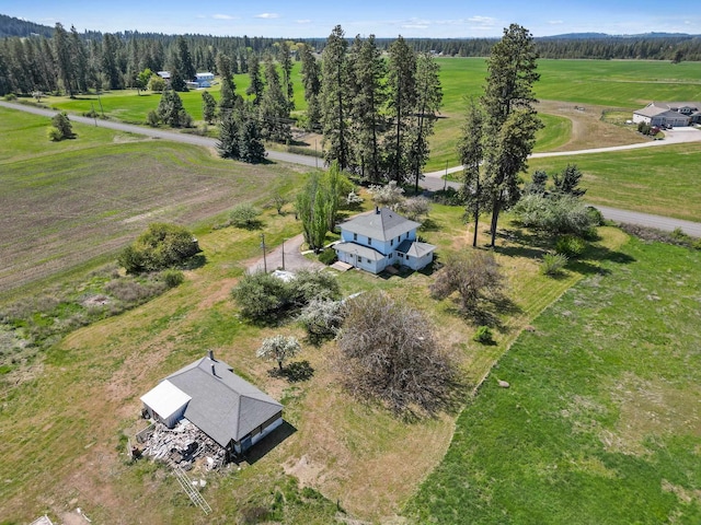 bird's eye view with a view of trees and a rural view